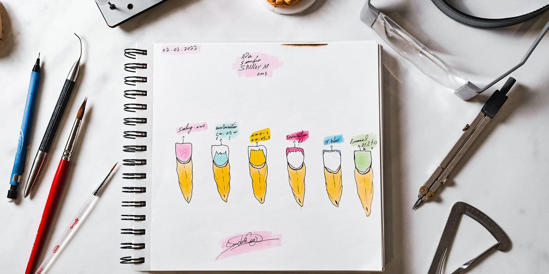 Hand-drawn smile design sketches of colored teeth beside dental instruments